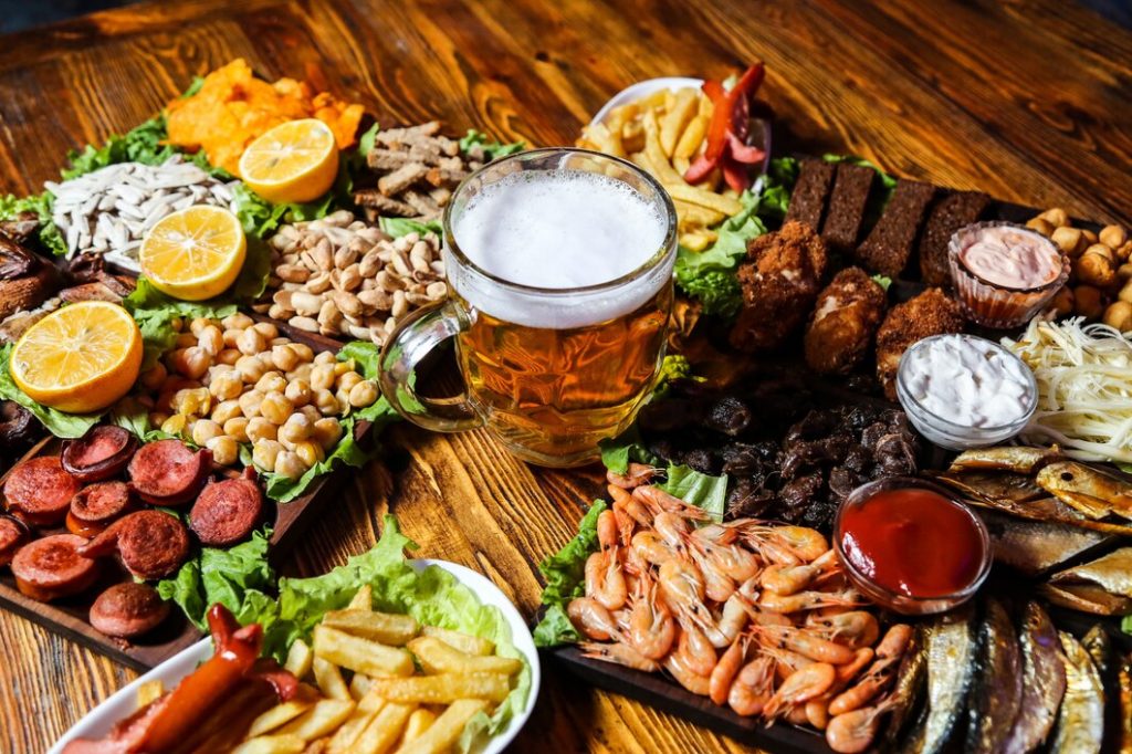 glass-beer-with-various-snacks-it-table_141793-16625